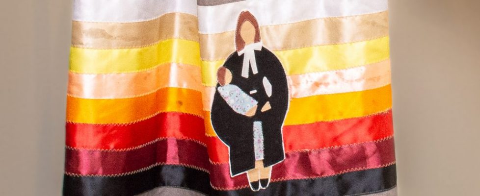 ribbon skirt with mother dressed as lawyer with child