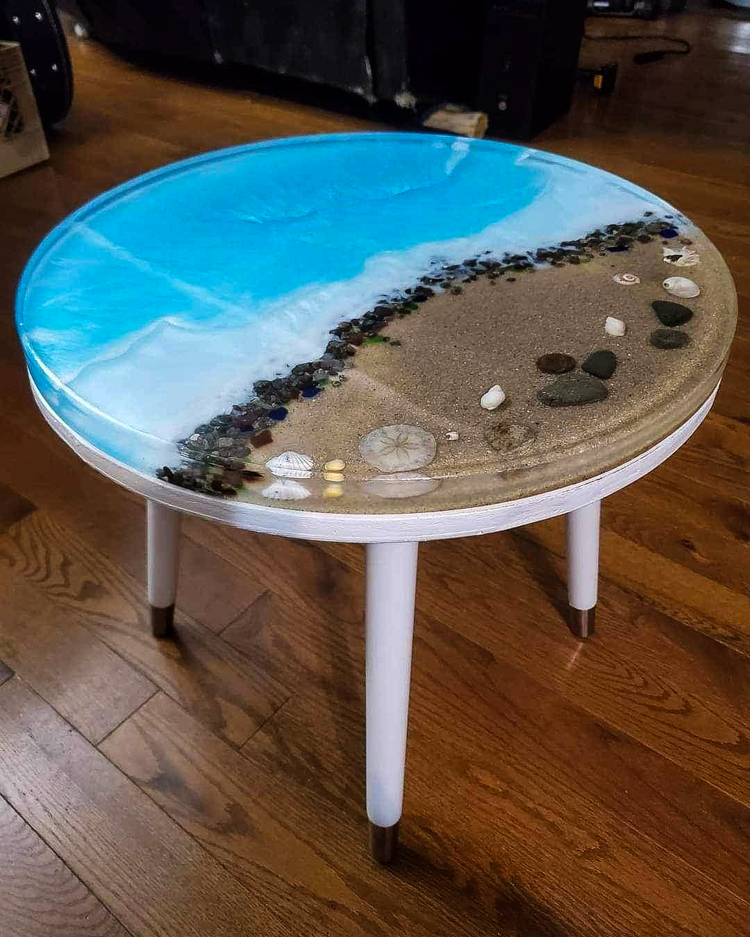 Coffee table with natural shells, stones and glass in resin.