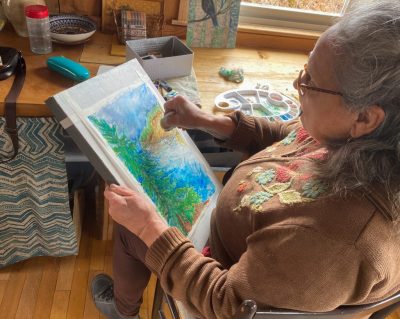 Elaine Mandrona seen here doing a watercolour in her studio.