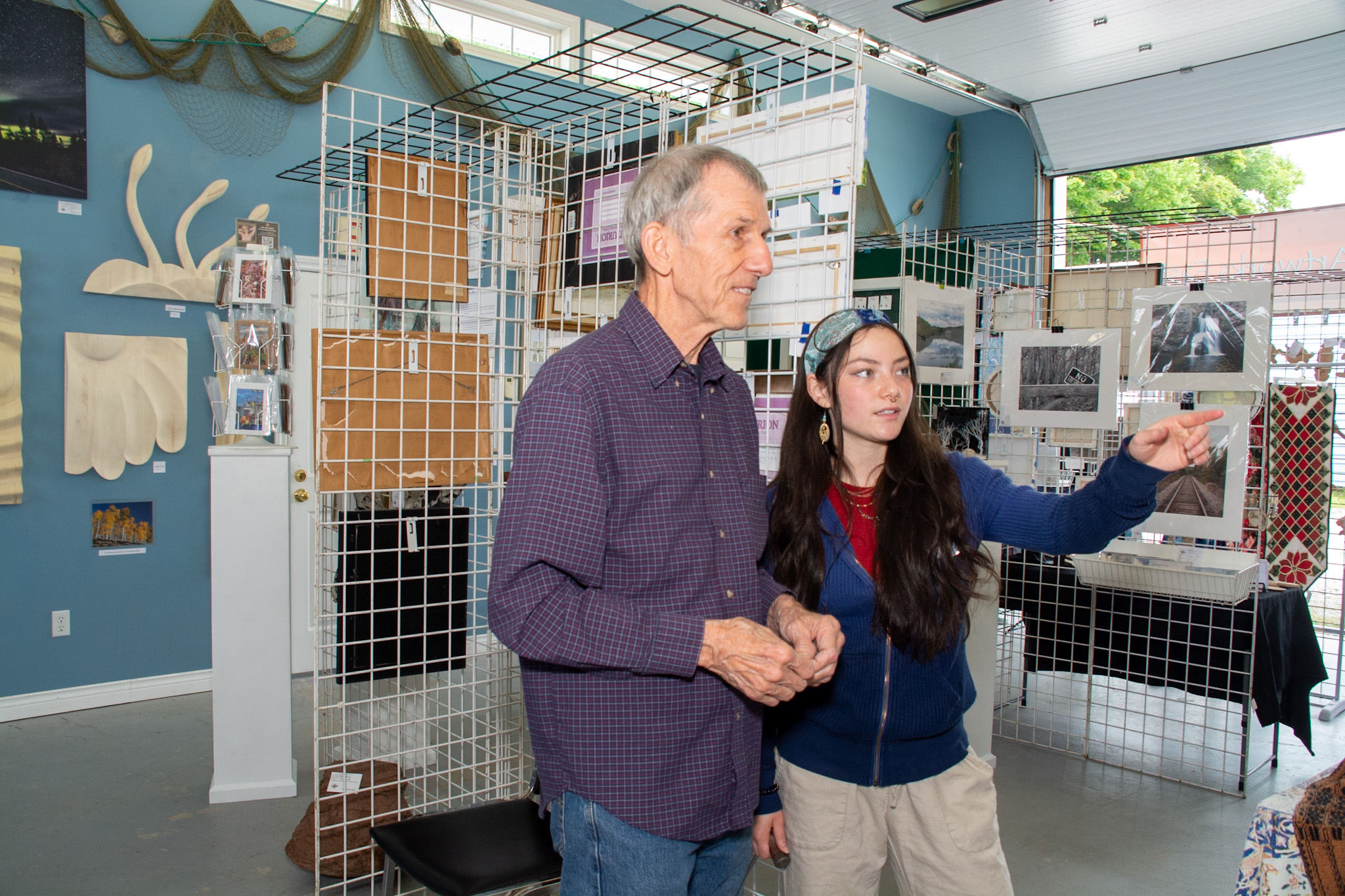 Jack Leonard and Suki Kamogawa discussing display issues in ArtWorks East's gallery in the boathouse at the marina in Guysborough. Suki is the student employee running the place. The first time she did it was when she was a volunteer at 13.