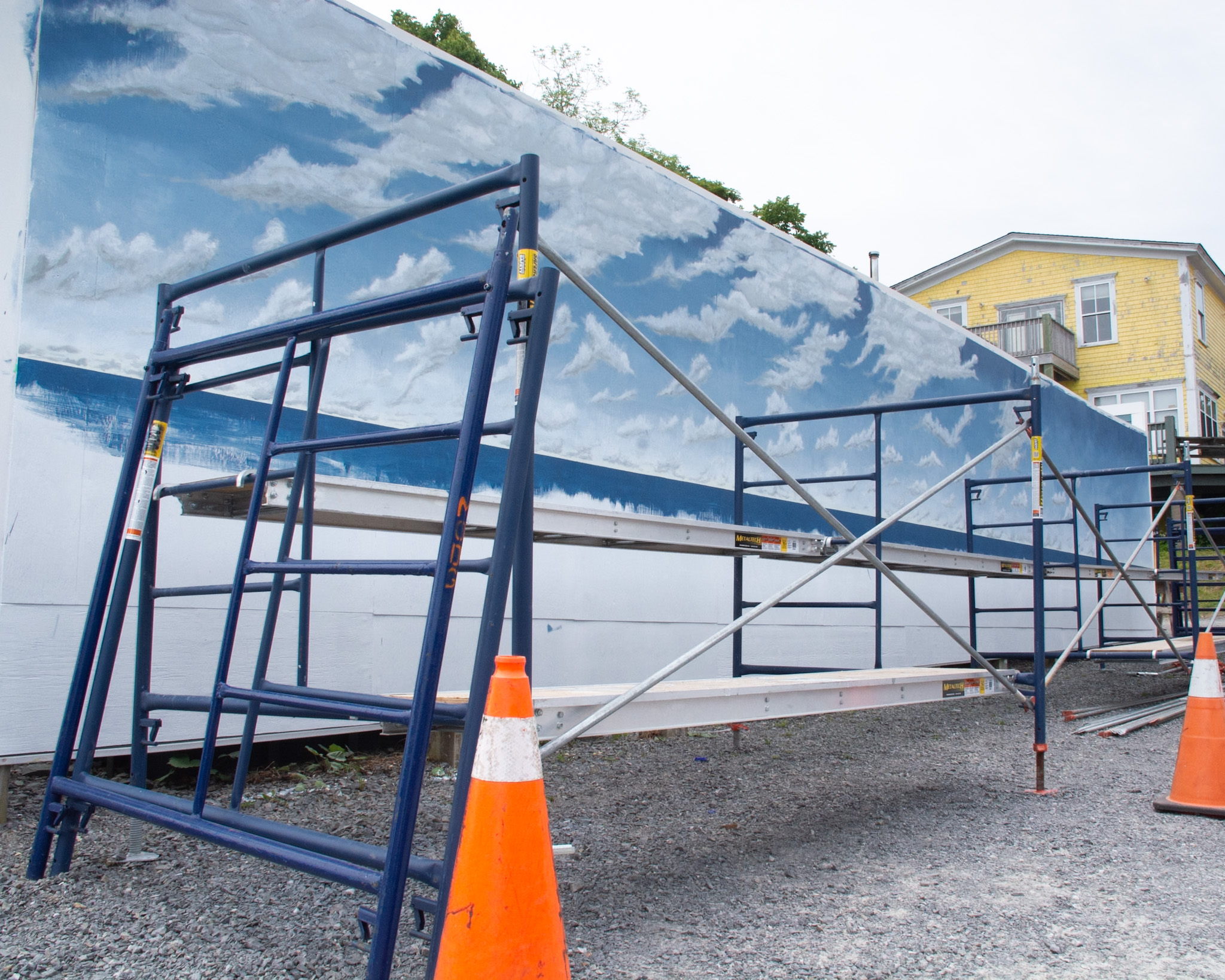 When we visited ArtWorks East's gallery, we were impressed by this mural that Kelly Harnish, a retired teacher, was working on which would depict historic peoples of the county. On the front  of the building, the water treatment plant, Moni Duersch was working on one called All are Welcome Here  which was an underwater world. She had help from local youth. 