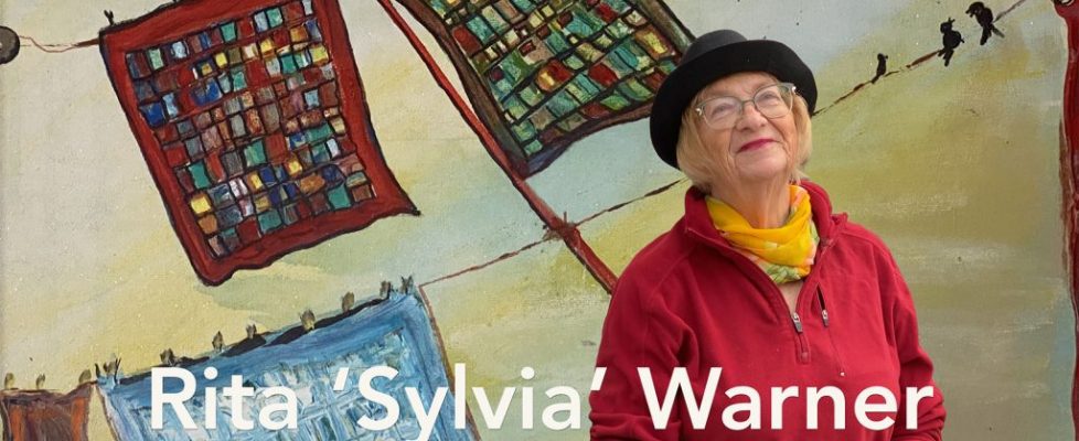 portrait of a painter with her painting as a backdrop